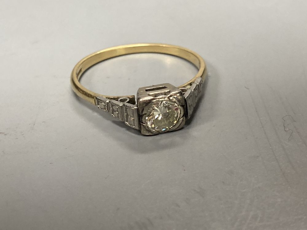 An early 20th century 18ct and solitaire diamond ring, size M/N, gross 2.3 grams.